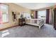 Bright main bedroom with carpet, a bed, nightstands, lamps and two windows at 4901 Ashbrook Cir, Highlands Ranch, CO 80130