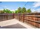 Private fenced backyard with a concrete patio and string lights, great for outdoor entertaining at 10309 W Fair Ave # E, Littleton, CO 80127