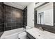 Updated bathroom features sleek tile work, modern fixtures, and a clean aesthetic at 10309 W Fair Ave # E, Littleton, CO 80127