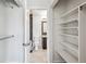 View through closet into bathroom featuring modern finishes, fixtures, tiling, and flooring at 10309 W Fair Ave # E, Littleton, CO 80127