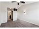 Bedroom with ceiling fan, neutral walls, and gray carpet, has ensuite bath at 10309 W Fair Ave # E, Littleton, CO 80127