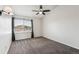 Bedroom with ceiling fan and gray carpet offers a relaxing space, complemented by natural light at 10309 W Fair Ave # E, Littleton, CO 80127