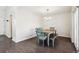 Charming dining room with stylish blue chairs, a wooden table, and modern lighting at 10309 W Fair Ave # E, Littleton, CO 80127
