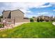 Landscaped common area featuring lush lawn, gravel beds, mature trees, and community signage at 10309 W Fair Ave # E, Littleton, CO 80127