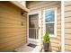 Close-up of a charming front door entrance with a welcome mat and decorative details at 10309 W Fair Ave # E, Littleton, CO 80127