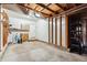 Spacious garage with white walls, concrete floor, overhead lighting, and ample storage space at 10309 W Fair Ave # E, Littleton, CO 80127