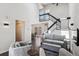 Spacious living room with wood floors, modern decor, and a staircase at 10309 W Fair Ave # E, Littleton, CO 80127
