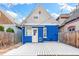 Charming backyard with a blue house, a wooden deck, and stylish string lights for evening ambiance at 3429 W 34Th Ave, Denver, CO 80211