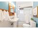 Cozy bathroom featuring a pedestal sink, shower with glass door, and light blue walls at 3429 W 34Th Ave, Denver, CO 80211