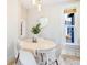 Cozy dining room features a modern round table, white chairs, and natural light at 3429 W 34Th Ave, Denver, CO 80211