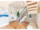 Bright foyer features hardwood floors, modern light fixture, and a staircase with wooden treads at 3429 W 34Th Ave, Denver, CO 80211