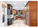 Well-lit kitchen with stainless steel appliances, wooden cabinetry, and tile flooring at 3429 W 34Th Ave, Denver, CO 80211