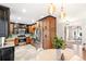 Open kitchen with stainless steel appliances, wooden cabinets, and a view to a dining area at 3429 W 34Th Ave, Denver, CO 80211