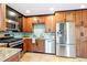 An eat-in kitchen features stainless appliances, tile backsplash, and granite countertops at 3429 W 34Th Ave, Denver, CO 80211