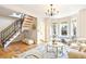 Bright living room with hardwood floors, bay window, and staircase at 3429 W 34Th Ave, Denver, CO 80211