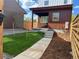 Landscaped backyard with a wooden fence and walkway at 6917 Kendrick Ln, Arvada, CO 80007