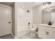 Clean bathroom with white subway tiles, a bathtub, and modern vanity at 6917 Kendrick Ln, Arvada, CO 80007