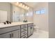 Modern bathroom with double vanity and a walk-in shower at 6917 Kendrick Ln, Arvada, CO 80007