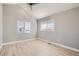 Spacious bedroom with hardwood floors and two windows at 6917 Kendrick Ln, Arvada, CO 80007