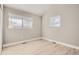 Bright bedroom with hardwood floors and two windows at 6917 Kendrick Ln, Arvada, CO 80007