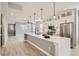 Modern kitchen with island, white cabinets, and stainless steel appliances at 6917 Kendrick Ln, Arvada, CO 80007