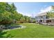 Expansive backyard featuring a pond, lush lawn, a wooden fence, and beautiful landscaping at 6726 W 97Th Cir, Westminster, CO 80021