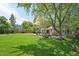 Well-maintained backyard features mature trees, wooden deck, landscaped areas, and ample green space at 6726 W 97Th Cir, Westminster, CO 80021