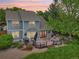 Backyard with a large deck, landscape, and mature trees, providing a serene outdoor living space at 6726 W 97Th Cir, Westminster, CO 80021