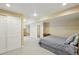 Finished basement with gray striped bed and ample storage featuring neutral walls and good lighting at 6726 W 97Th Cir, Westminster, CO 80021