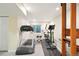 Home gym featuring a treadmill, elliptical, and weightlifting station in a well-lit finished basement at 6726 W 97Th Cir, Westminster, CO 80021