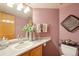 Powder room featuring soft, rosy walls and neutral decor for a calming touch at 6726 W 97Th Cir, Westminster, CO 80021