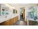 Bathroom showcasing a double sink vanity, walk-in shower, and soaking tub at 6726 W 97Th Cir, Westminster, CO 80021