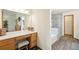 Bathroom vanity area with wood cabinets, neutral countertops, and ample lighting at 6726 W 97Th Cir, Westminster, CO 80021