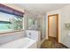 Bright bathroom featuring a glass-enclosed shower and a soaking tub at 6726 W 97Th Cir, Westminster, CO 80021