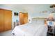 Cozy bedroom with light blue walls, a queen-sized bed, and wood furniture at 6726 W 97Th Cir, Westminster, CO 80021