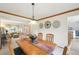 Inviting dining room featuring wood trim, modern lighting, and an open flow to the living area at 6726 W 97Th Cir, Westminster, CO 80021
