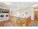 Open upstairs hallway with laundry area and decorative light fixture at 6726 W 97Th Cir, Westminster, CO 80021