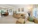 Comfortable living room with neutral tones, plush seating, and an open dining area at 6726 W 97Th Cir, Westminster, CO 80021
