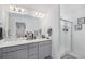 Bright bathroom featuring a double vanity and a pristine glass-enclosed shower for a modern touch at 20932 E 60Th Ave, Aurora, CO 80019