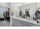 Stylish bathroom with a double vanity and an adjacent walk-in closet, offering plenty of storage at 20932 E 60Th Ave, Aurora, CO 80019