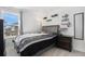 Comfortable bedroom featuring a window view and modern shelving, designed for relaxation and style at 20932 E 60Th Ave, Aurora, CO 80019