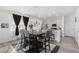 Bright dining area with a modern table and chairs, seamlessly connected to a stylish kitchen with white countertops at 20932 E 60Th Ave, Aurora, CO 80019