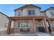 Charming two-story home featuring a covered front porch with stone accents and stylish gray siding at 20932 E 60Th Ave, Aurora, CO 80019