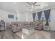 Comfortable living room with a large sectional sofa, stylish decor, and plenty of natural light from the window at 20932 E 60Th Ave, Aurora, CO 80019