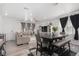 Open-concept living and dining area featuring a comfortable sofa, dining table, and plenty of natural light at 20932 E 60Th Ave, Aurora, CO 80019