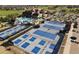 Aerial view showcasing tennis courts, pickleball courts, pool, and clubhouse in a Primary-planned community at 7693 S Quantock Way, Aurora, CO 80016