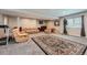 Spacious basement offers plush carpet, neutral paint, and comfortable seating area at 7693 S Quantock Way, Aurora, CO 80016