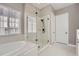 A luxurious bathroom featuring a soaking tub and a frameless shower enclosure at 7693 S Quantock Way, Aurora, CO 80016