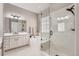 Bright bathroom features a soaking tub, glass shower, and double vanity with modern fixtures at 7693 S Quantock Way, Aurora, CO 80016
