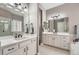 Elegant bathroom with double vanities, white cabinetry, and a walk-in shower at 7693 S Quantock Way, Aurora, CO 80016